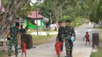 Senyum Anak-Anak Warnai Hasil Pembangunan Jalan Cor 250 Meter TMMD Ke-129 di Kampung Sesor